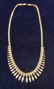 A 9 carat gold necklace of graduated lozenge and cut lozenge design, 43 cm long overall,