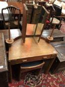 An early 20th Century Arts and Crafts style oak dressing table of small proportions,