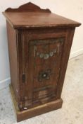 A late Victorian oak and carved and painted pot cupboard in the Arts & Crafts manner,