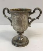 A Victorian silver trophy cup with embossed decoration and panel depicting a cockerel and hen in a