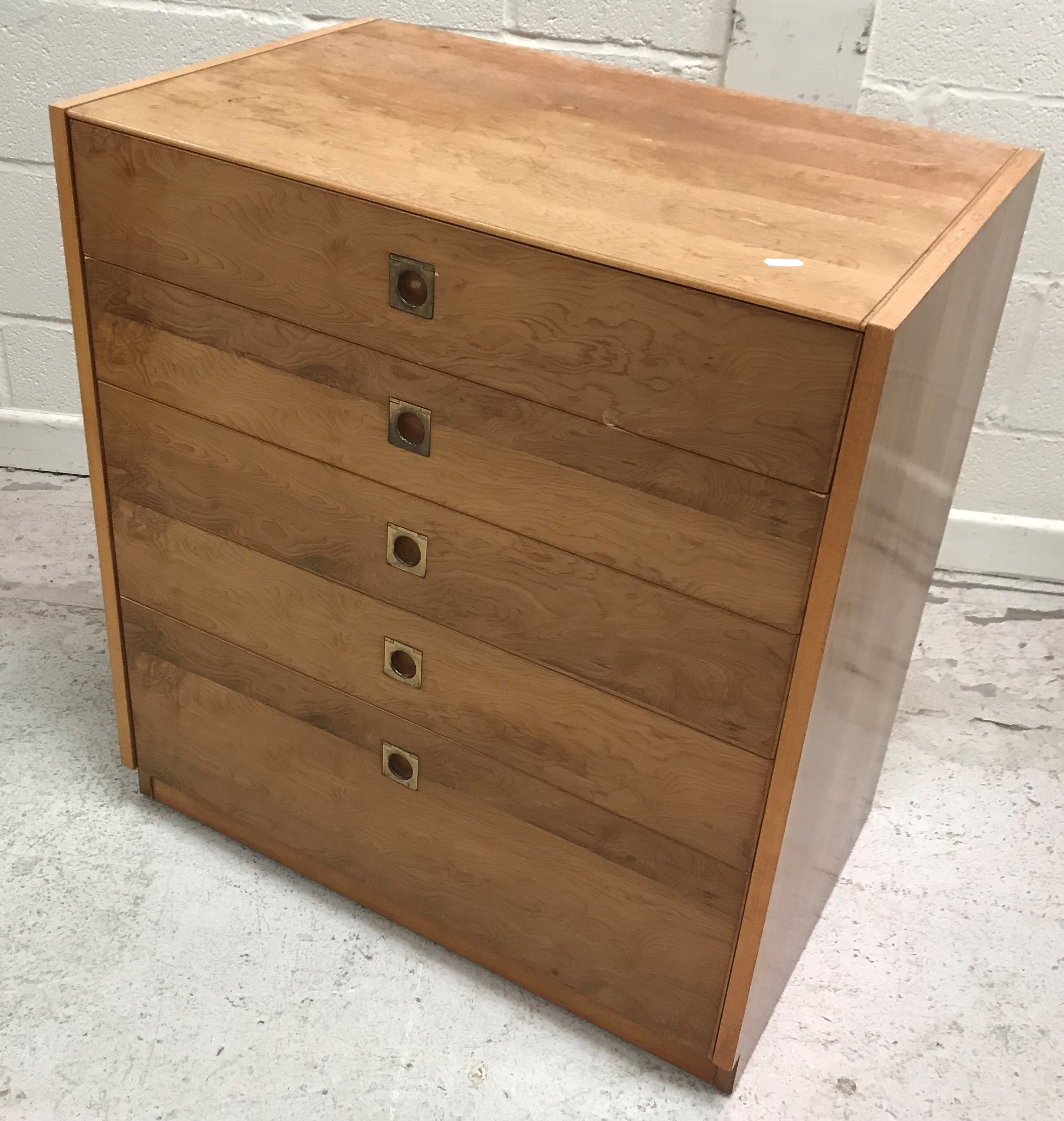 A 1960's yew wood chest of five long graduated drawers with brass flush handles,