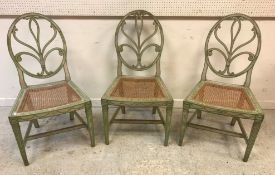A set of three circa 1800 Provincial Hepplewhite painted chairs with oval backs and foliate carved