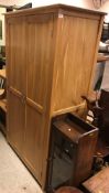 A modern oak two door wardrobe in the Arts & Crafts style, dated verso "11 September 2013",