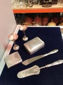 A collection of silver items to include a silver cigarette box, a pair of loaded silver spill vases,