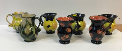 Three Rosie Jackson daffodil decorated baluster shaped mugs, 11 cm high each signed below handle,