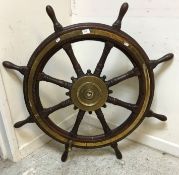 A 19th Century brass bound teak ship's wheel inscribed to brass work "Edwards & Co, Ltd.