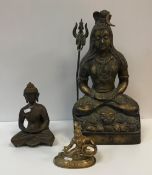 An Indian bronze figure of Shiva seated in double lotus meditative position upon a lion skin rug,