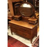 An Edwardian mahogany dressing chest with mirrored super structure over two short and one long