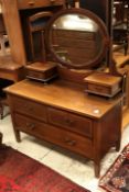 An Edwardian mahogany dressing chest with mirrored super structure over two short and one long