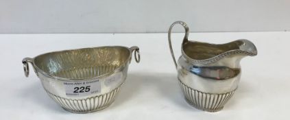 A Victorian silver cream jug of oval semi-fluted form with harebell relief work banding (by Thomas