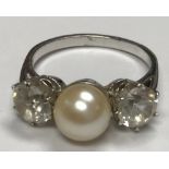 A white gold mounted (un-marked) pearl and white sapphire dress ring,