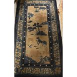 A Chinese rug, the central panel set with horses in landscape on fawn ground,