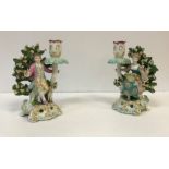 A pair of Samson bocage figural candlesticks as figures in 18th Century dress with dogs,