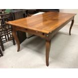 A modern oak farmhouse style kitchen table in the French manner attributed to I and JL Brown of