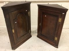 A George III oak hanging corner cupboard,