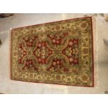 A Chobli rug, the central panel set with foliate decoration on a burgundy ground,