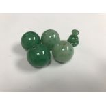 An oval Scandinavian wooden box containing two pairs of large jade beads and a turned bead