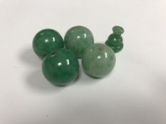 An oval Scandinavian wooden box containing two pairs of large jade beads and a turned bead