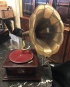 An HMV table top gramophone with brass horn on simulated rosewood stained base,