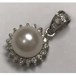 A 9 carat white gold and pearl mounted pendant with diamond set loop, pearl size approx 13,