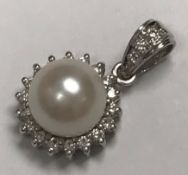 A 9 carat white gold and pearl mounted pendant with diamond set loop, pearl size approx 13,