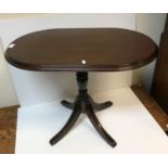 A modern mahognay occasional table by Archer and Smith for Harrods bearign lable to base,