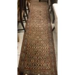 A modern Persian design runner with all-over lozenge floral set medallion decoration on a fawn and