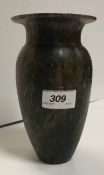 An Egyptian hand-carved soapstone vase of urn form with flared rim of mottled green/brown