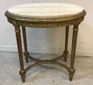 A circa 1900 carved giltwood and gesso framed oval occasional table,