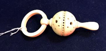 A carved ivory rattle teether inscribed "Estcourt from R.W. 1923.