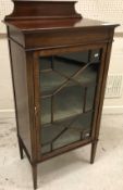 An Edwardian mahogany display cabinet with single glazed door on square tapered legs,