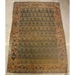 A Kashan rug, the central panel set with repeating hook motifs on a fawn and blue ground,