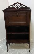 A circa 1900 mahogany student's bureau with fretwork carved three-quarter gallery over a fall-front