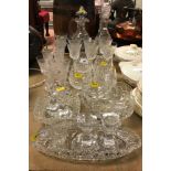 A collection of glassware to include two pineapple cut glass decanters, one with handle,