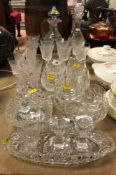 A collection of glassware to include two pineapple cut glass decanters, one with handle,