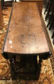 An 18th Century oak oval gate-leg drop-leaf dining table,