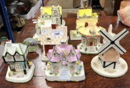 A collection of nine Coalport cottage ornaments, including "The Old Curiosity Shop",