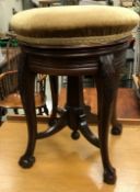 A Victorian mahogany circular adjustable piano stool by James Shoolbred,