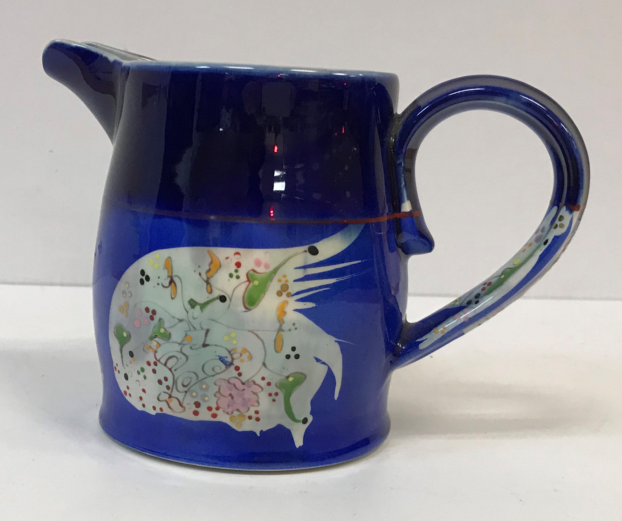 A Martina O'Leary fish decorated jug, designed by Roger Mitchell, signed to base, 12.