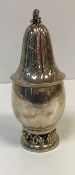 A Georg Jensen silver sugar caster, the top of flower head form with a grape and vine finial,