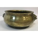 A Chinese bronze censer with stylised lion mask handles bearing faux Qianlong four character mark