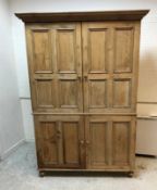 A Victorian waxed pine cupboard,