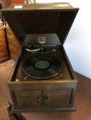 An HMV oak-cased table top gramophone with rising caddy top over two sound doors, 47.