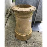 A pale terracotta chimney pot of plain cylindrical form,