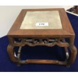 An early 20th Century Chinese rosewood framed marble top urn stand of square form with scrollwork
