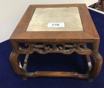 An early 20th Century Chinese rosewood framed marble top urn stand of square form with scrollwork