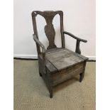 A circa 1800 Provincial walnut and oak commode armchair with box seat, raised on shaped supports,