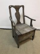 A circa 1800 Provincial walnut and oak commode armchair with box seat, raised on shaped supports,