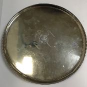 A George III silver salver of plain circular form, with beaded edge,