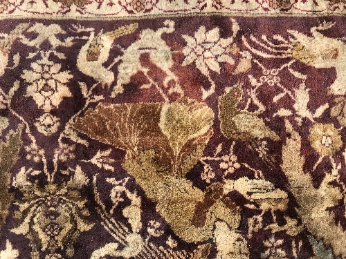 An early 20th Century Agra North India carpet with centre medallion on a wine-coloured ground, - Image 92 of 103